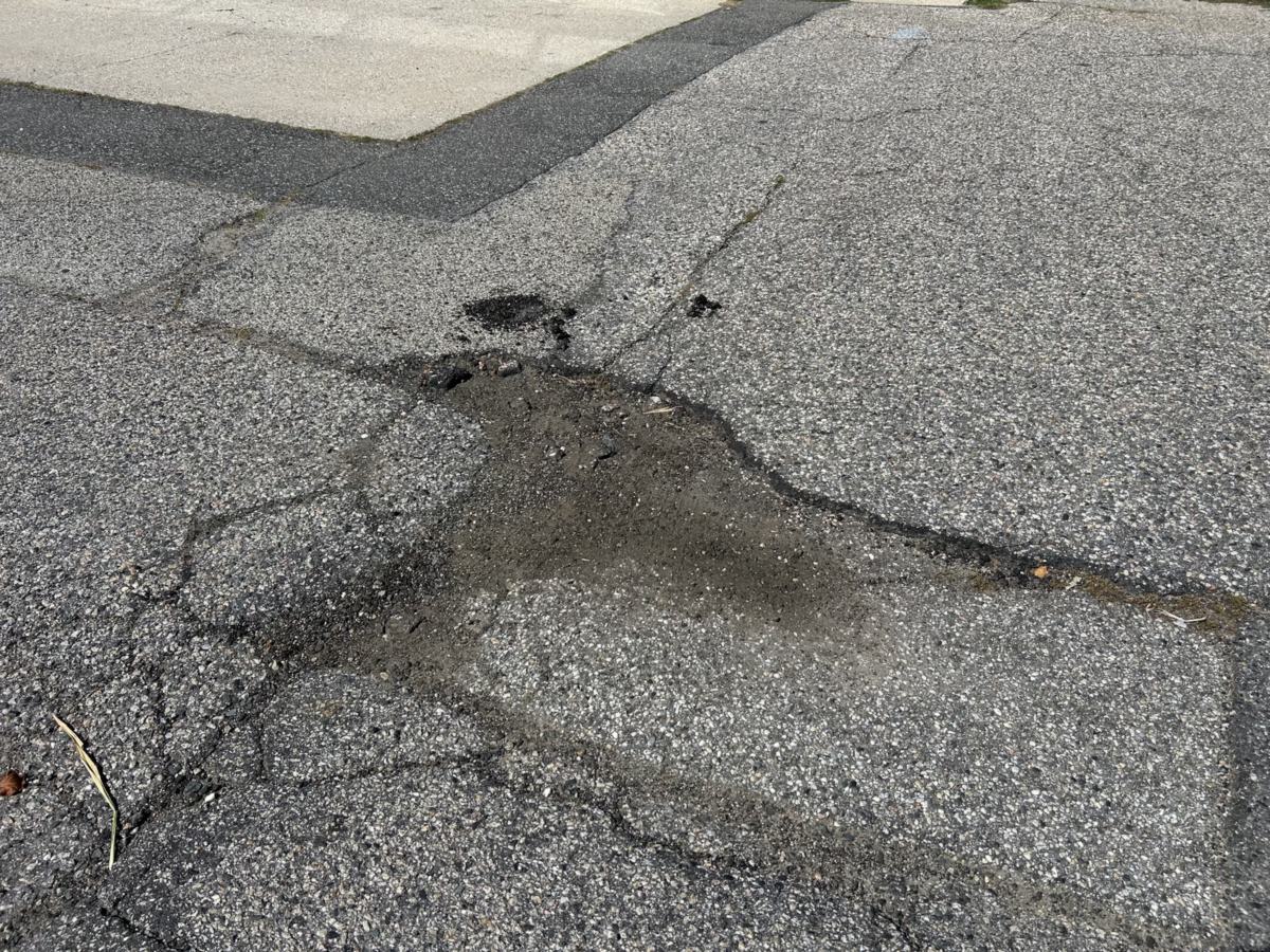 Cracked, crumbling asphalt letting water into the base before crack filling