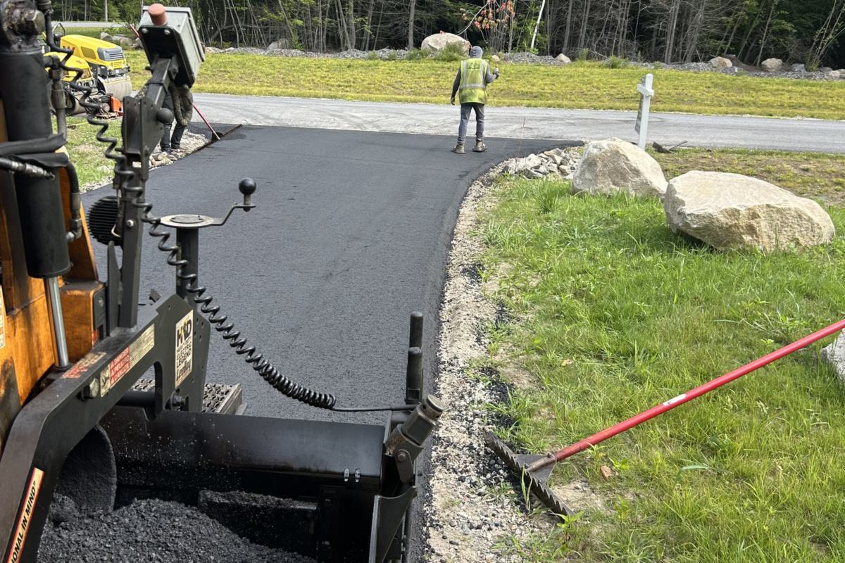 Zilembo's asphalt paver laying hot asphalt for a new driveway in Southern Maine