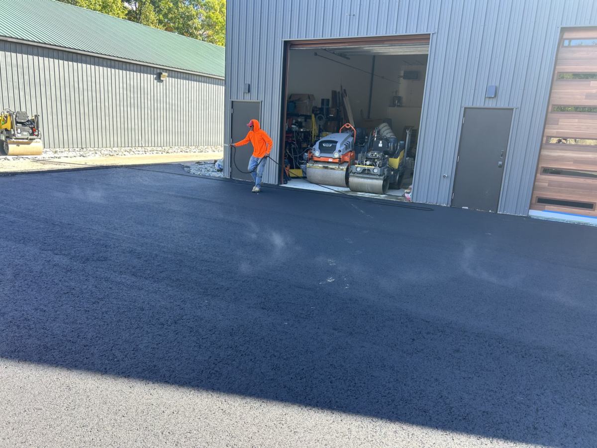 Zilembo's crew member spraying sealcoat on a commercial lot in Southern Maine