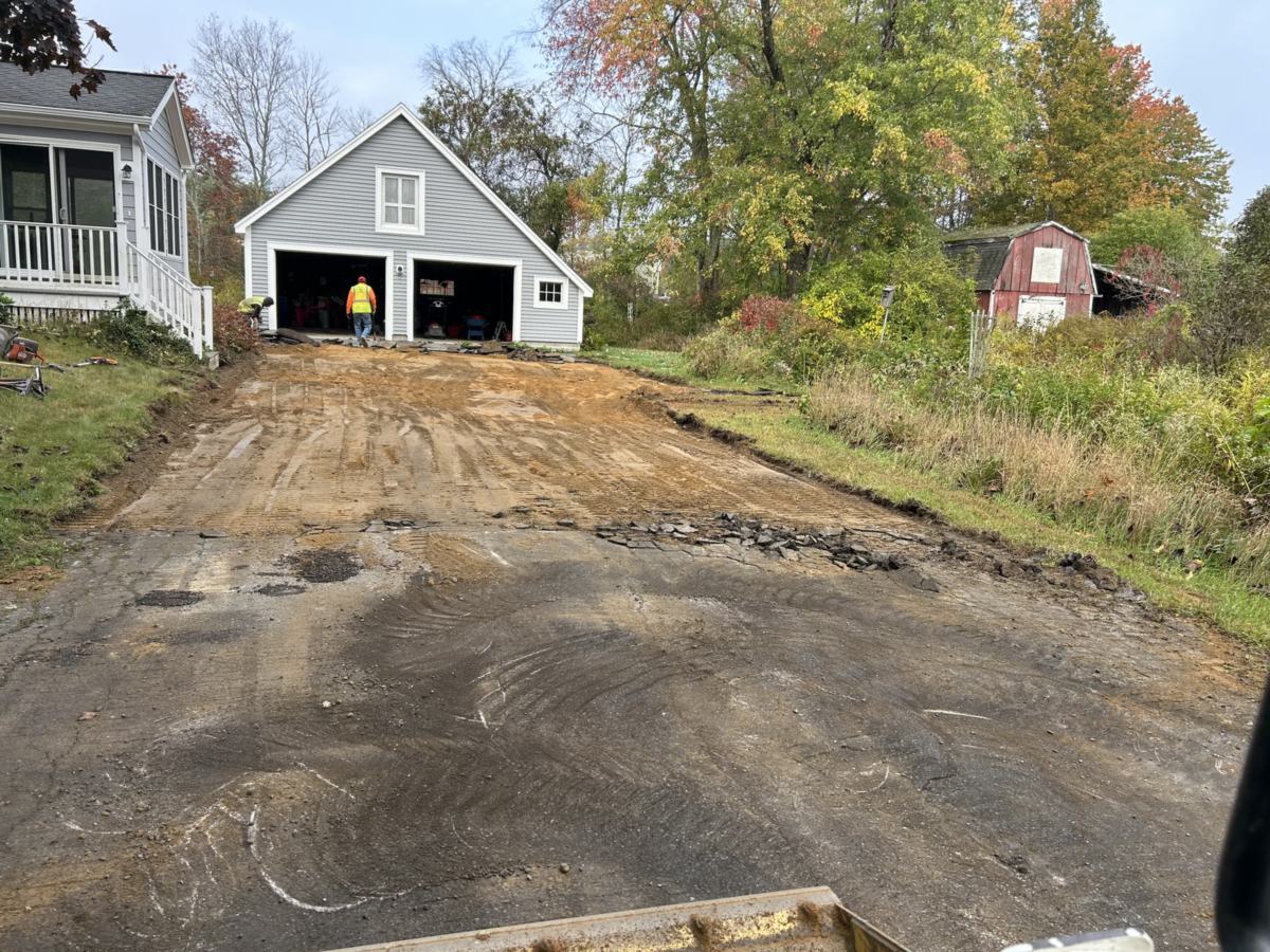 Old asphalt removed and gravel base graded for a new driveway in Southern Maine